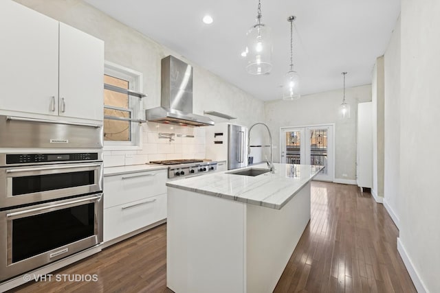 3342 S Giles Ave, Chicago, IL 60616 - kitchen with wall chimney exhaust hood, appliances with stainless steel finishes, a sink, and white cabinets