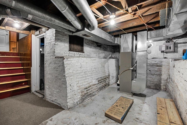 913 N Mason St, Bloomington, IL 61701 - unfinished below grade area featuring heating unit, stairs, and electric panel