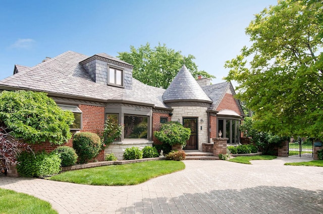 1902 N 77th Ct, Elmwood Park, IL 60707 - view of front of property featuring a high end roof, brick siding, stone siding, and a gate