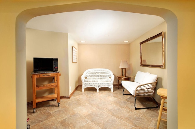 1902 N 77th Ct, Elmwood Park, IL 60707 - living area with arched walkways, recessed lighting, and light stone finish floors