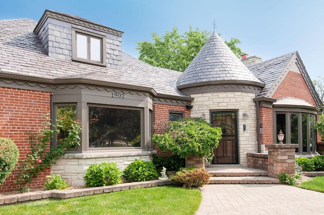 1902 N 77th Ct, Elmwood Park, IL 60707 - view of front facade with a high end roof, brick siding, and a chimney