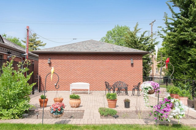 1902 N 77th Ct, Elmwood Park, IL 60707 - view of side of home with a shingled roof, a patio, and brick siding