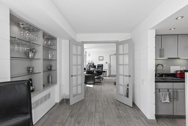 1255 N Sandburg Ter Unit 2912, Chicago, IL 60610 - indoor bar featuring french doors, wood finished floors, decorative backsplash, recessed lighting, and radiator heating unit