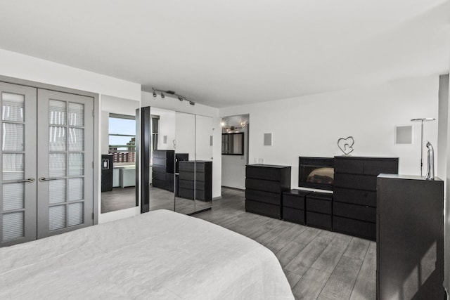 1255 N Sandburg Ter Unit 2912, Chicago, IL 60610 - bedroom featuring wood finished floors, french doors, and rail lighting