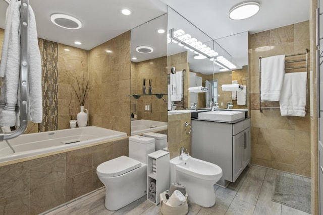 1255 N Sandburg Ter Unit 2912, Chicago, IL 60610 - bathroom featuring tile walls, a bidet, a relaxing tiled tub, vanity, and toilet
