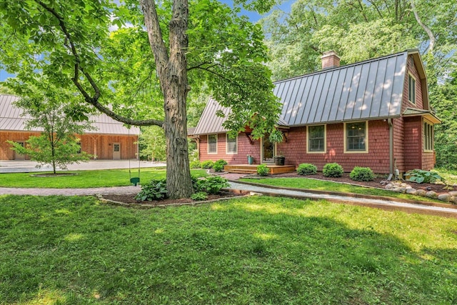 2804 E Concord Rd, Urbana, IL 61802 - view of front of property featuring a standing seam roof, a chimney, a metal roof, and a front lawn