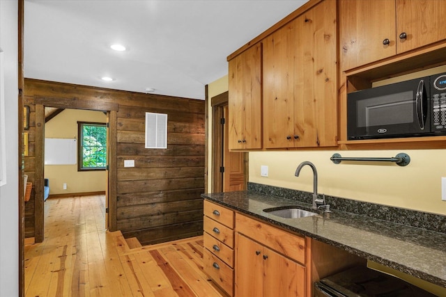 2804 E Concord Rd, Urbana, IL 61802 - kitchen featuring black microwave, light wood-style floors, recessed lighting, dark stone countertops, and brown cabinets