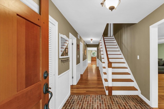 2804 E Concord Rd, Urbana, IL 61802 - entrance foyer featuring stairway, brick patterned flooring, and wainscoting
