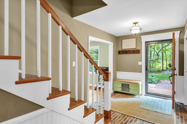 2804 E Concord Rd, Urbana, IL 61802 - entryway with stairs, a wainscoted wall, and brick patterned floors