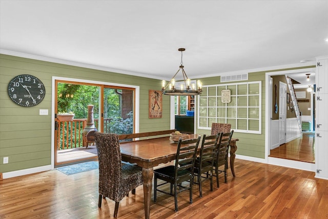 2804 E Concord Rd, Urbana, IL 61802 - dining room featuring wood finished floors, crown molding, a chandelier, and a decorative wall