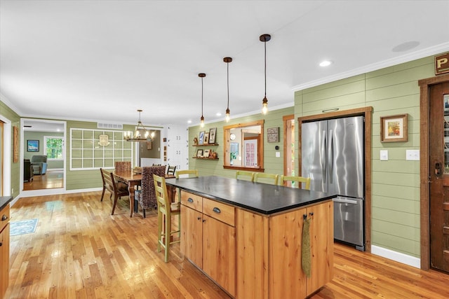 2804 E Concord Rd, Urbana, IL 61802 - kitchen featuring freestanding refrigerator, ornamental molding, dark countertops, light wood finished floors, and a center island
