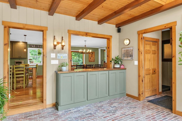 2804 E Concord Rd, Urbana, IL 61802 - kitchen with green cabinetry, brick floors, a chandelier, a wood ceiling with exposed beams, and wood walls