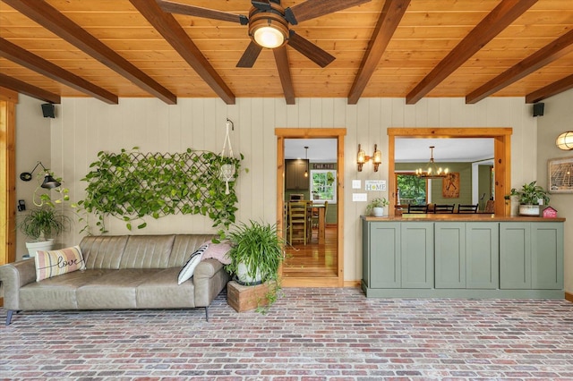 2804 E Concord Rd, Urbana, IL 61802 - living room with a wood ceiling with exposed beams, ceiling fan, a chandelier, brick patterned floors, and wooden walls