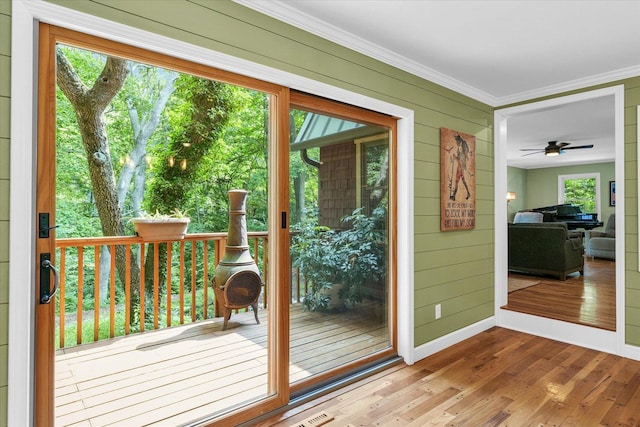 2804 E Concord Rd, Urbana, IL 61802 - doorway with wood-type flooring, ornamental molding, wood walls, and a ceiling fan
