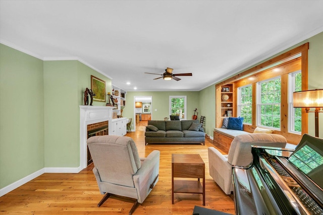 2804 E Concord Rd, Urbana, IL 61802 - living area with crown molding, ceiling fan, a fireplace, light wood-style flooring, and recessed lighting