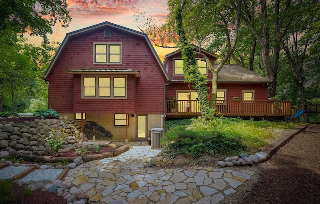 2804 E Concord Rd, Urbana, IL 61802 - view of front facade with a gambrel roof, a deck, and a patio area