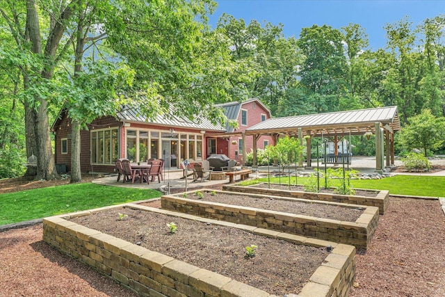 2804 E Concord Rd, Urbana, IL 61802 - back of house featuring a standing seam roof, a patio, a lawn, and a metal roof