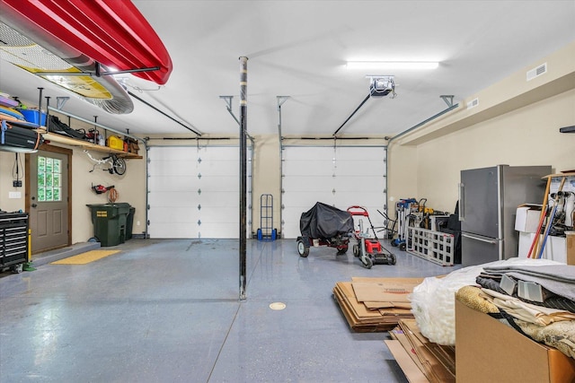 2804 E Concord Rd, Urbana, IL 61802 - garage featuring freestanding refrigerator and a garage door opener