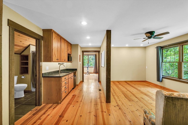 2804 E Concord Rd, Urbana, IL 61802 - kitchen with dark countertops, brown cabinetry, light wood-style flooring, healthy amount of natural light, and recessed lighting