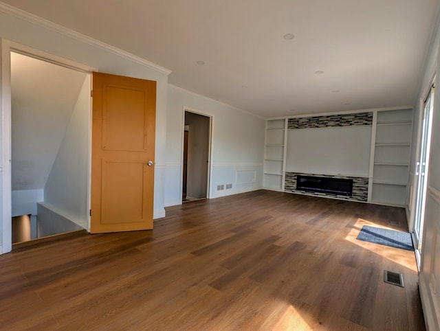 235 E Manchester Dr, Wheeling, IL 60090 - unfurnished living room with built in features, wood finished floors, crown molding, a decorative wall, and wainscoting