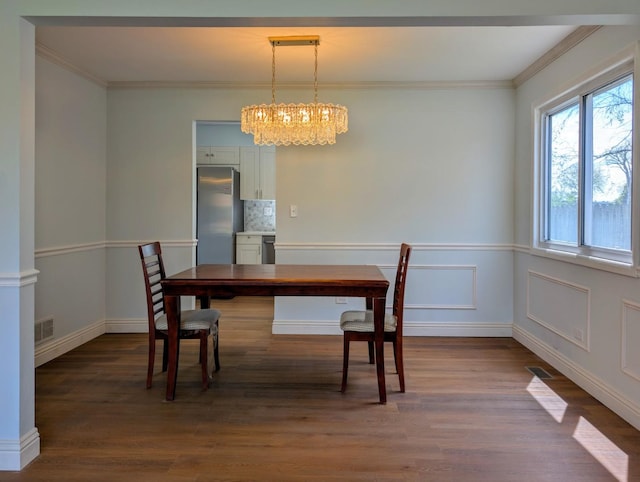 235 E Manchester Dr, Wheeling, IL 60090 - unfurnished dining area with a chandelier, crown molding, and dark wood finished floors