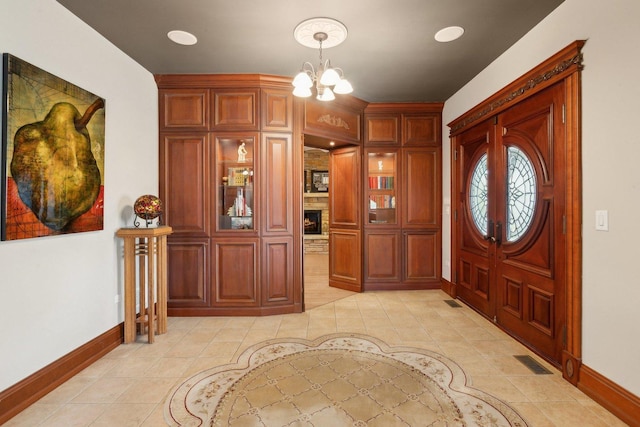 1424 Glencoe Ave, Highland Park, IL 60035 - entryway with baseboards, light tile patterned flooring, and a chandelier