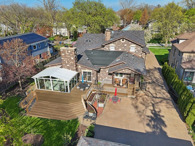 1424 Glencoe Ave, Highland Park, IL 60035 - back of property featuring a deck, a chimney, a sunroom, and a residential view