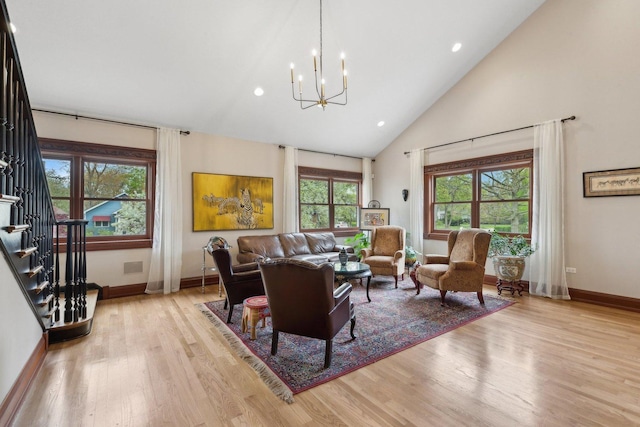 1424 Glencoe Ave, Highland Park, IL 60035 - living room featuring a chandelier, baseboards, light wood-style floors, stairway, and high vaulted ceiling