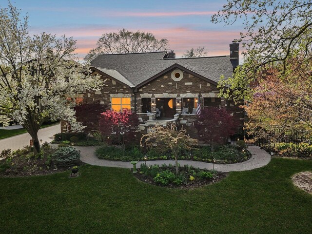 1424 Glencoe Ave, Highland Park, IL 60035 - tudor-style house featuring a lawn, roof with shingles, and a chimney