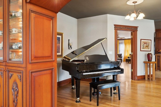 1424 Glencoe Ave, Highland Park, IL 60035 - living area with light wood-style floors, baseboards, and a chandelier