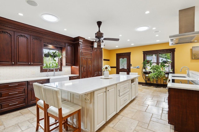 1424 Glencoe Ave, Highland Park, IL 60035 - kitchen featuring a sink, stone tile floors, a center island, ceiling fan, and recessed lighting