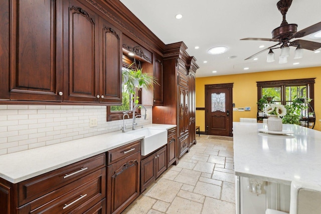 1424 Glencoe Ave, Highland Park, IL 60035 - kitchen featuring a sink, stone tile floors, recessed lighting, decorative backsplash, and light countertops