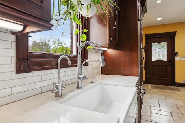 1424 Glencoe Ave, Highland Park, IL 60035 - kitchen featuring a sink, decorative backsplash, recessed lighting, stone tile floors, and dark brown cabinets