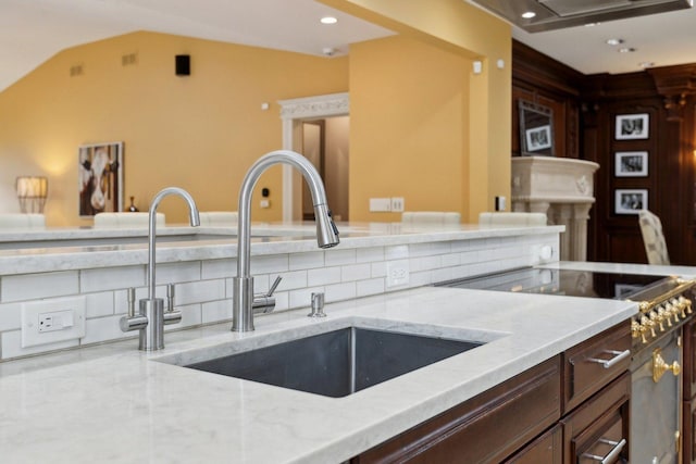 1424 Glencoe Ave, Highland Park, IL 60035 - kitchen with a sink, light stone counters, range, dark brown cabinetry, and recessed lighting