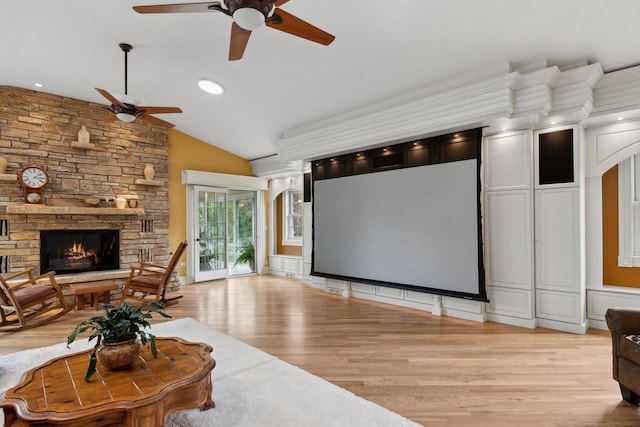 1424 Glencoe Ave, Highland Park, IL 60035 - cinema featuring a ceiling fan, light wood-style flooring, a fireplace, lofted ceiling, and a decorative wall