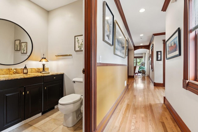 1424 Glencoe Ave, Highland Park, IL 60035 - hallway featuring arched walkways, baseboards, a sink, light wood-style floors, and recessed lighting