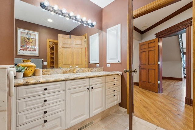 1424 Glencoe Ave, Highland Park, IL 60035 - bathroom featuring vanity, tile patterned flooring, crown molding, and baseboards