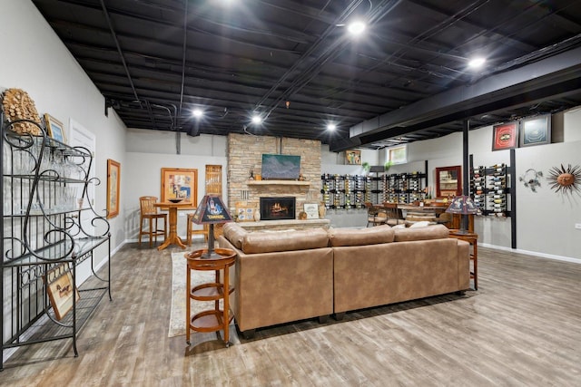 1424 Glencoe Ave, Highland Park, IL 60035 - living room featuring wood finished floors, baseboards, a stone fireplace, and a dry bar
