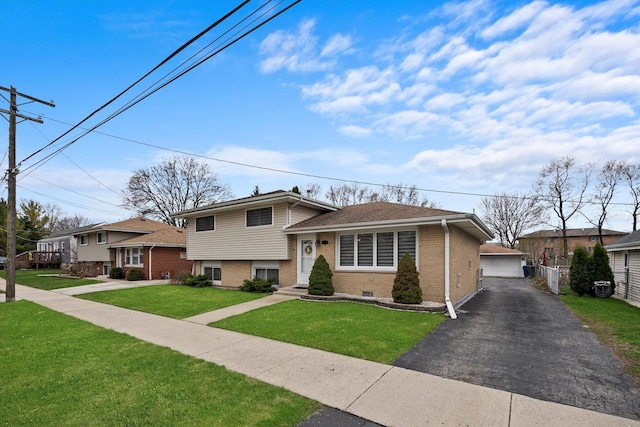 7011 Avon Ave, Oak Lawn, IL 60453 - tri-level home with brick siding, a front yard, and a garage