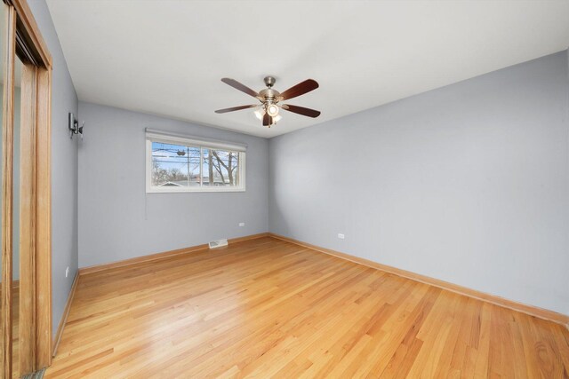 7011 Avon Ave, Oak Lawn, IL 60453 - unfurnished room featuring wood finished floors, a ceiling fan, and baseboards