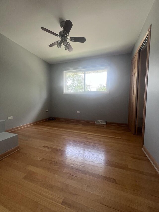 7011 Avon Ave, Oak Lawn, IL 60453 - unfurnished room featuring light wood finished floors, baseboards, and a ceiling fan
