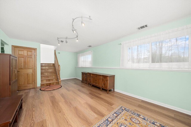 7011 Avon Ave, Oak Lawn, IL 60453 - bonus room featuring wood finished floors, stairway, baseboards, and a textured ceiling