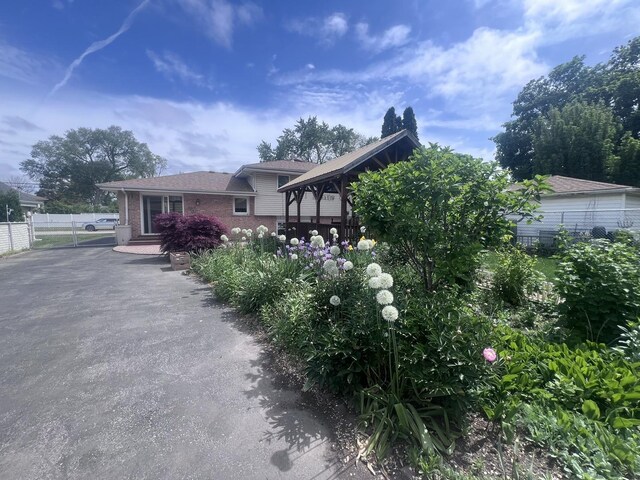 7011 Avon Ave, Oak Lawn, IL 60453 - view of front of house with brick siding, a gazebo, and driveway