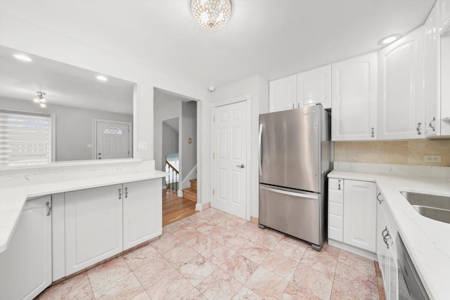 7011 Avon Ave, Oak Lawn, IL 60453 - kitchen with appliances with stainless steel finishes, white cabinetry, light stone counters, recessed lighting, and a sink