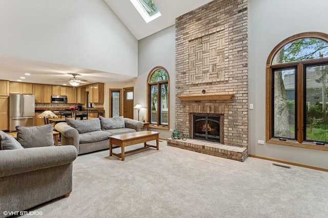 1021 Oxford St, Downers Grove, IL 60516 - living area featuring high vaulted ceiling, light colored carpet, a fireplace, a skylight, and a ceiling fan