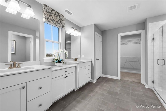 2093 Squire Cir, Yorkville, IL 60560 - bathroom with a shower stall, a walk in closet, vanity, and baseboards