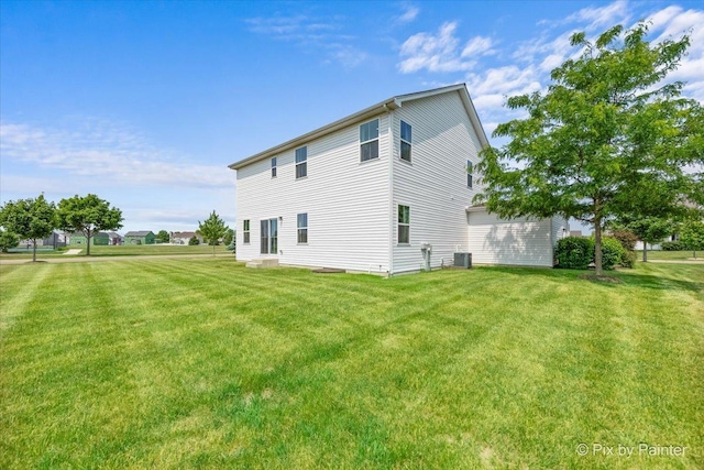 2093 Squire Cir, Yorkville, IL 60560 - view of property exterior featuring a lawn, a garage, and cooling unit