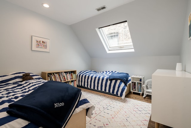 2117 W Dickens Ave, Chicago, IL 60647 - bedroom featuring a skylight, lofted ceiling, wood finished floors, and recessed lighting