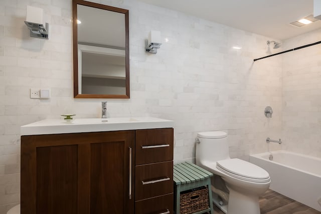 2117 W Dickens Ave, Chicago, IL 60647 - full bath featuring tile walls, toilet, vanity, washtub / shower combination, and wood finished floors