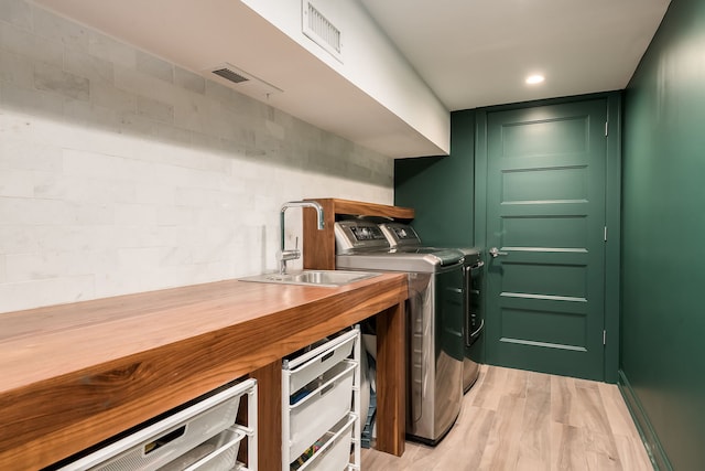 2117 W Dickens Ave, Chicago, IL 60647 - washroom with washing machine and clothes dryer and light wood finished floors